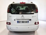 a picture of a small white car parked in a room