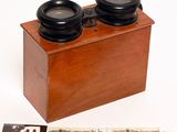 a wooden box with two binoculars on top of it