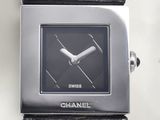 a black watch with a silver face on a black leather strap