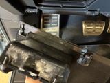 a close up of a car ' s dashboard with a steering control