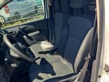 the interior of a car with the door open and the driver ' s seat down