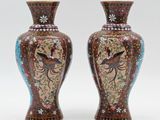 pair of vases decorated with birds and flowers on a white background