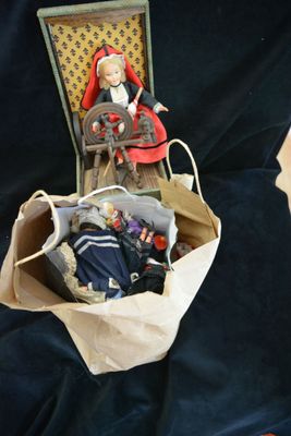 a doll sitting in a suitcase with a doll in it