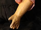 a close up of a mannequin wearing a pink blouse and black skirt