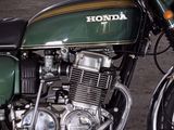 a green motorcycle that is parked in a parking lot