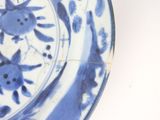 a blue and white plate with a cat design on it