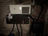 a white microwave sitting on top of a wall in a dark room
