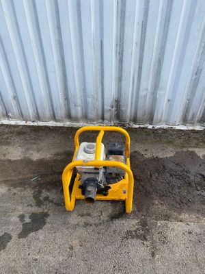 a small yellow generator sitting on the ground next to a building