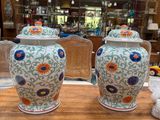 two vases that are sitting on a table