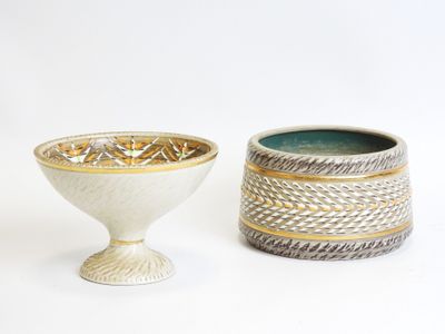 two vases sitting next to each other on a white surface