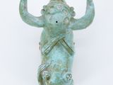 a statue of an elephant with a trumpet in its hand