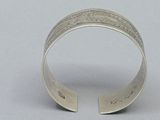 silver cuff bracelet with engraved design on the inside