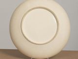 a white plate sitting on top of a wooden table