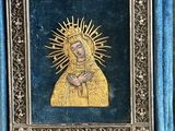 a gold and blue box with a picture of the virgin mary in it
