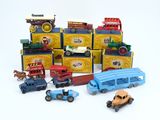 a lot of toy cars and trucks on a white surface