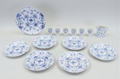 blue and white porcelain dishes and cups and saucers on a table