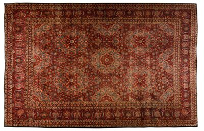 a red rug with a medallion design on a white background