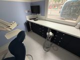 an image of a dental office with a desk and chair
