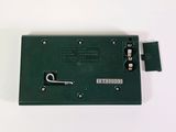 a green electronic device that is sitting on a white surface