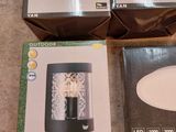 three boxes of light fixtures sitting on the floor next to each other