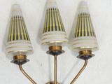 three lamps that are on the wall next to each other