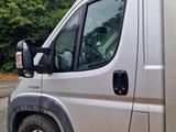 a silver van that is parked on the side of the road