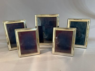 a set of four gold picture frames with purple glass in them
