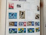 an open book with stamps on the pages and a picture of a man on a surfboard