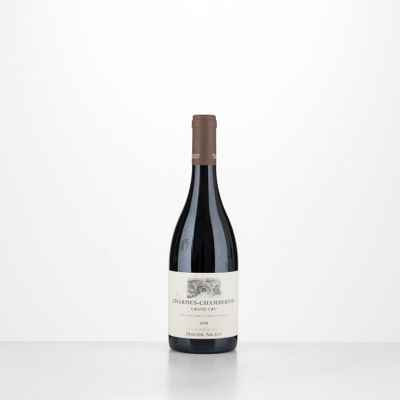 a bottle of red wine sitting on top of a table
