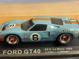 a blue and orange model of a racing car in a clear box