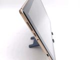 a tablet computer sitting on a stand on a white surface