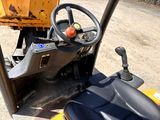 a close up of the steering and steering wheel of a construction vehicle