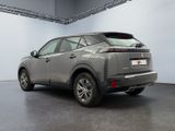the rear end of a silver suv parked in a garage