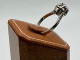 an image of a diamond ring sitting on top of a wooden box