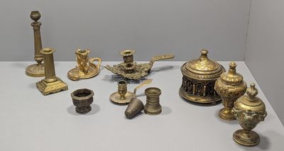 many different types of brass objects displayed on a table