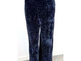 the woman is wearing a pair of blue pants and a white shirt