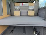a small bed in the back of a van