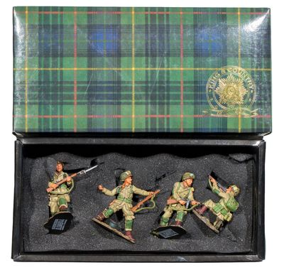 toy soldiers in a box on a white background with a tartan background