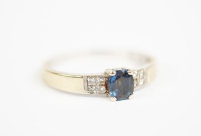 a blue sapphire and diamond ring on a white background
