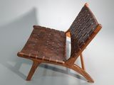 a wooden chair that has a woven seat on it