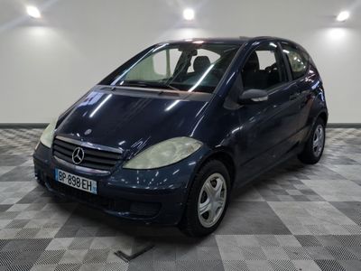 a picture of a small blue car parked in a garage