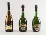 three bottles of champagne sitting next to each other on a white surface