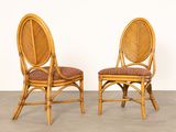 pair of vintage rattan chairs with upholstered cushions