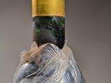 a bottle of wine wrapped in a plastic wrapper