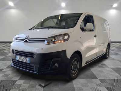 the white van is parked on a checkered floor in a room
