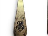two spoons and a fork with a monogram on them