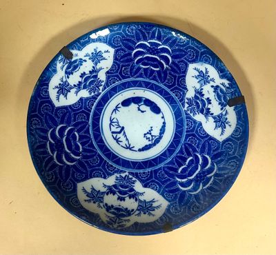 a blue and white plate with oriental designs on it