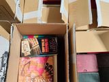 two boxes of books and a pair of shoes on the floor