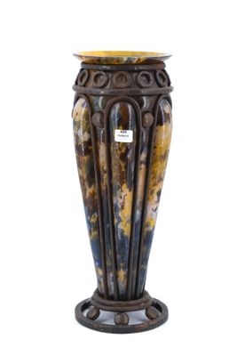 a vase that is sitting on a stand on a white background