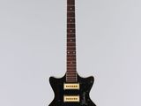 an electric guitar hanging from a string on a wall